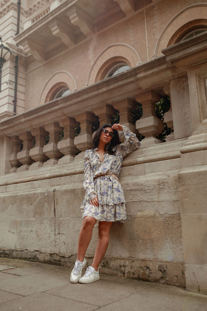 Luxury fashion blogger Shloka Narang of The Silk Sneaker shares how to pair a midi summer dress with sneakers for a casual summer outfit featuring a floral dress from & Other Stories and Veja sneakers