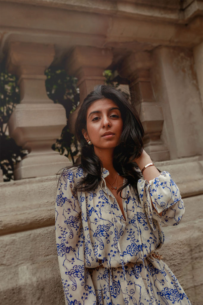 Luxury fashion blogger Shloka Narang of The Silk Sneaker shares how to pair a midi summer dress with sneakers for a casual summer outfit featuring a floral dress from & Other Stories and Veja sneakers