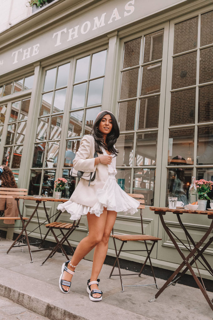 Luxury fashion blogger Shloka Narang of The Silk Sneaker shares how to style a blazer for a summer outfit featuring Sandro and Prada