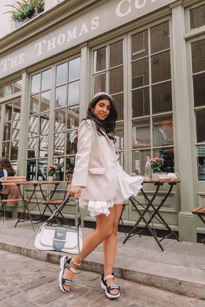 Luxury fashion blogger Shloka Narang of The Silk Sneaker shares how to style a blazer for a summer outfit featuring Sandro and Prada
