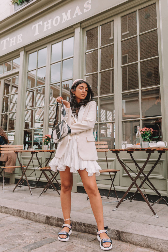 Luxury fashion blogger Shloka Narang of The Silk Sneaker shares how to style a blazer for a summer outfit featuring Sandro and Prada
