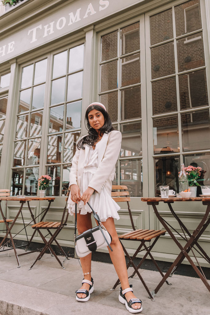 Luxury fashion blogger Shloka Narang of The Silk Sneaker shares how to style a blazer for a summer outfit featuring Sandro and Prada