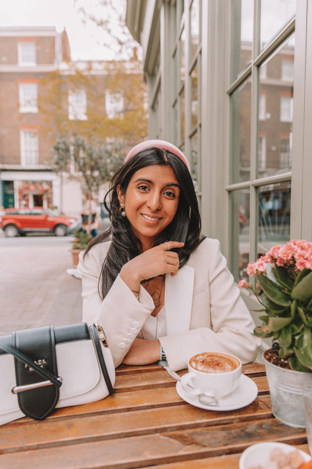 Luxury fashion blogger Shloka Narang of The Silk Sneaker shares how to style a blazer for a summer outfit featuring Sandro and Prada