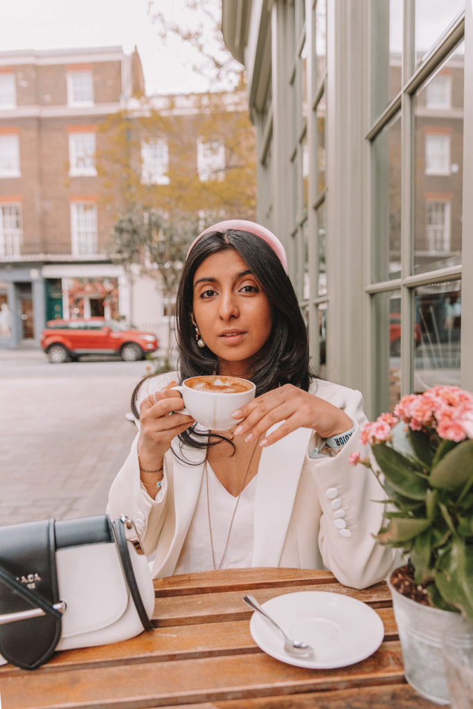Luxury fashion blogger Shloka Narang of The Silk Sneaker shares how to style a blazer for a summer outfit featuring Sandro and Prada