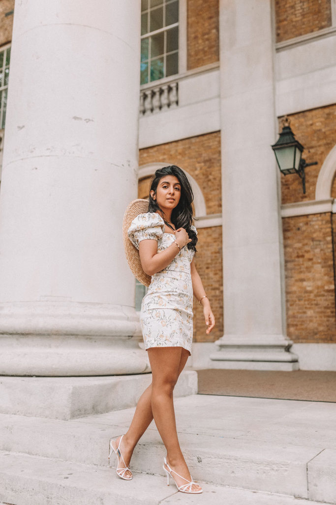 Luxury fashion blogger Shloka Narang of The Silk Sneaker shares how to style a mini summer dress for a cute summer holiday outfit featuring & Other Stories floral dress and prada sandals