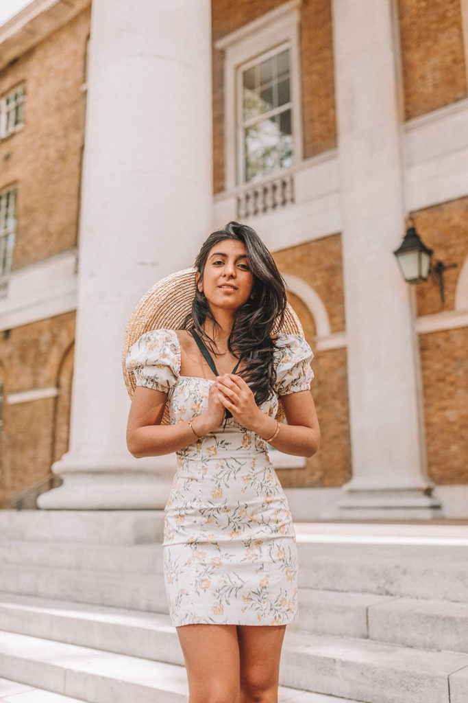 Luxury fashion blogger Shloka Narang of The Silk Sneaker shares how to style a mini summer dress for a cute summer holiday outfit featuring & Other Stories floral dress and prada sandals