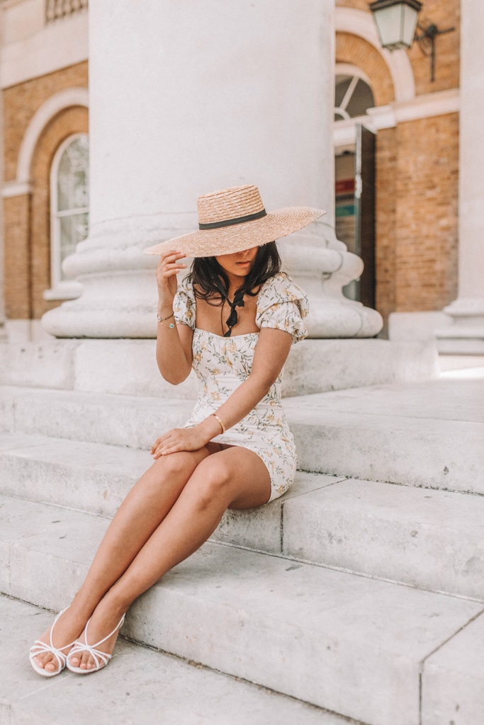 Luxury fashion blogger Shloka Narang of The Silk Sneaker shares how to style a mini summer dress for a cute summer holiday outfit featuring & Other Stories floral dress and prada sandals