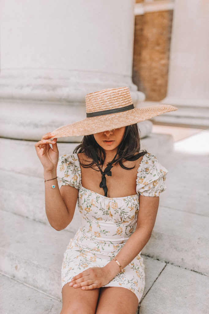 Luxury fashion blogger Shloka Narang of The Silk Sneaker shares how to style a mini summer dress for a cute summer holiday outfit featuring & Other Stories floral dress and prada sandals