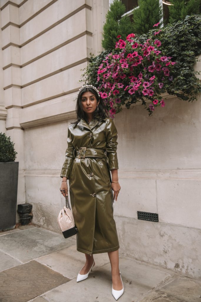 Fashion blogger Shloka Narang of The Silk Sneaker shares her London Fashion Week Streetstyle in a Topshop vinyl trench coat and pearl headband