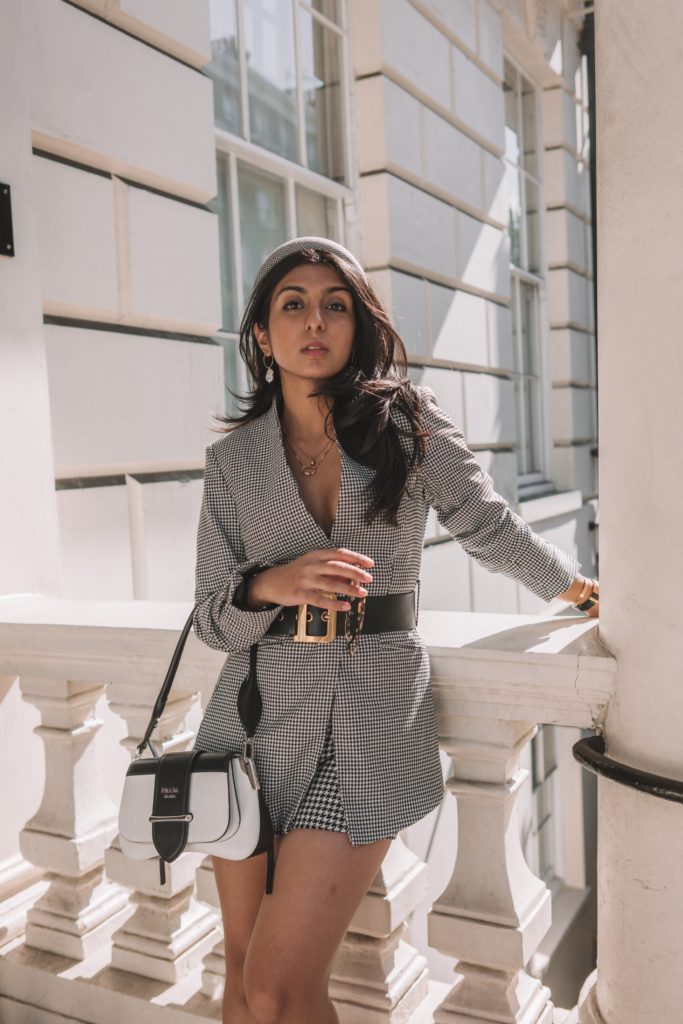 Fashion blogger Shloka Narang of The Silk Sneaker shares her London Fashion Week Streetstyle in a houndstooth blazer and shorts and headband featuring Dior, Prada and Zara