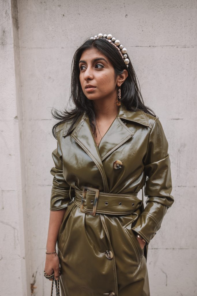 Fashion blogger Shloka Narang of The Silk Sneaker shares her London Fashion Week Streetstyle in a Topshop vinyl trench coat and pearl headband