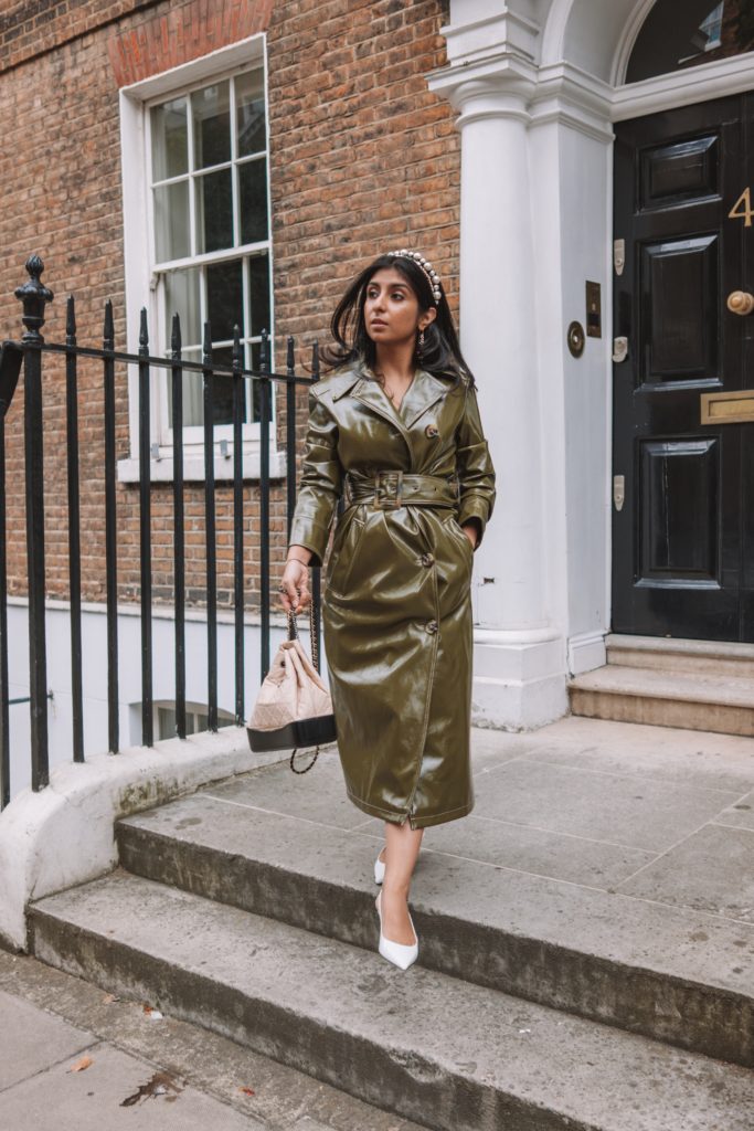 Fashion blogger Shloka Narang of The Silk Sneaker shares her London Fashion Week Streetstyle in a Topshop vinyl trench coat and pearl headband