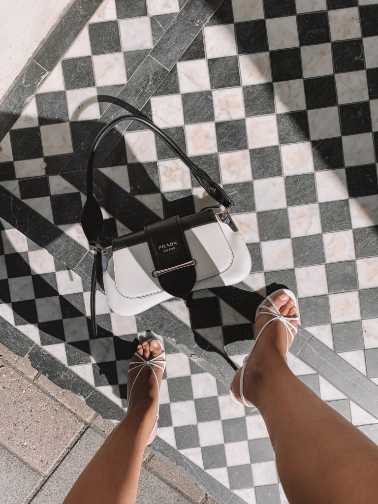 Fashion blogger Shloka Narang of The Silk Sneaker shares her London Fashion Week Streetstyle in a houndstooth blazer and shorts and headband featuring Dior, Prada and Zara