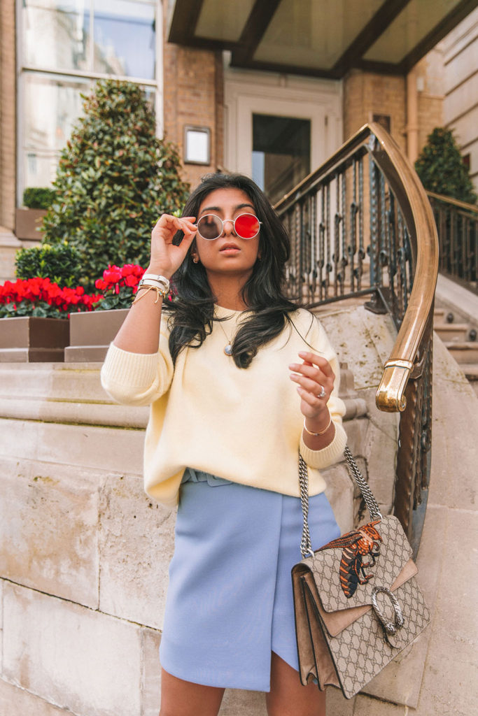 Luxury fashion blogger Shloka Narang of The Silk Sneaker shares three colour trends to wear for your next winter outfit featuring a blue & Other Stories belted skirt and a yellow oversized sweater