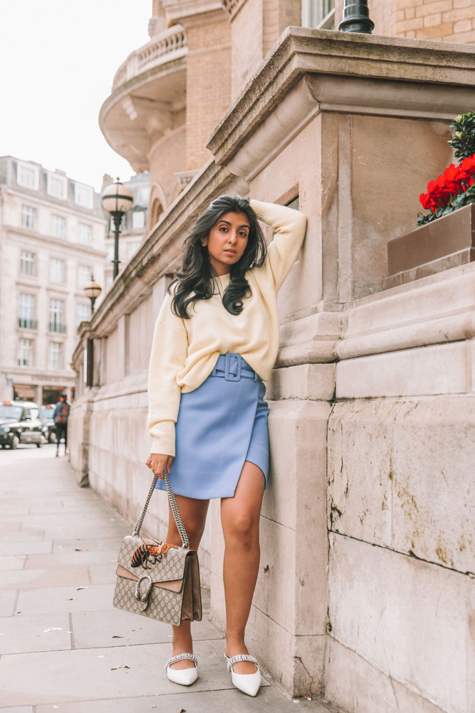 Luxury fashion blogger Shloka Narang of The Silk Sneaker shares three colour trends to wear for your next winter outfit featuring a blue & Other Stories belted skirt and a yellow oversized sweater