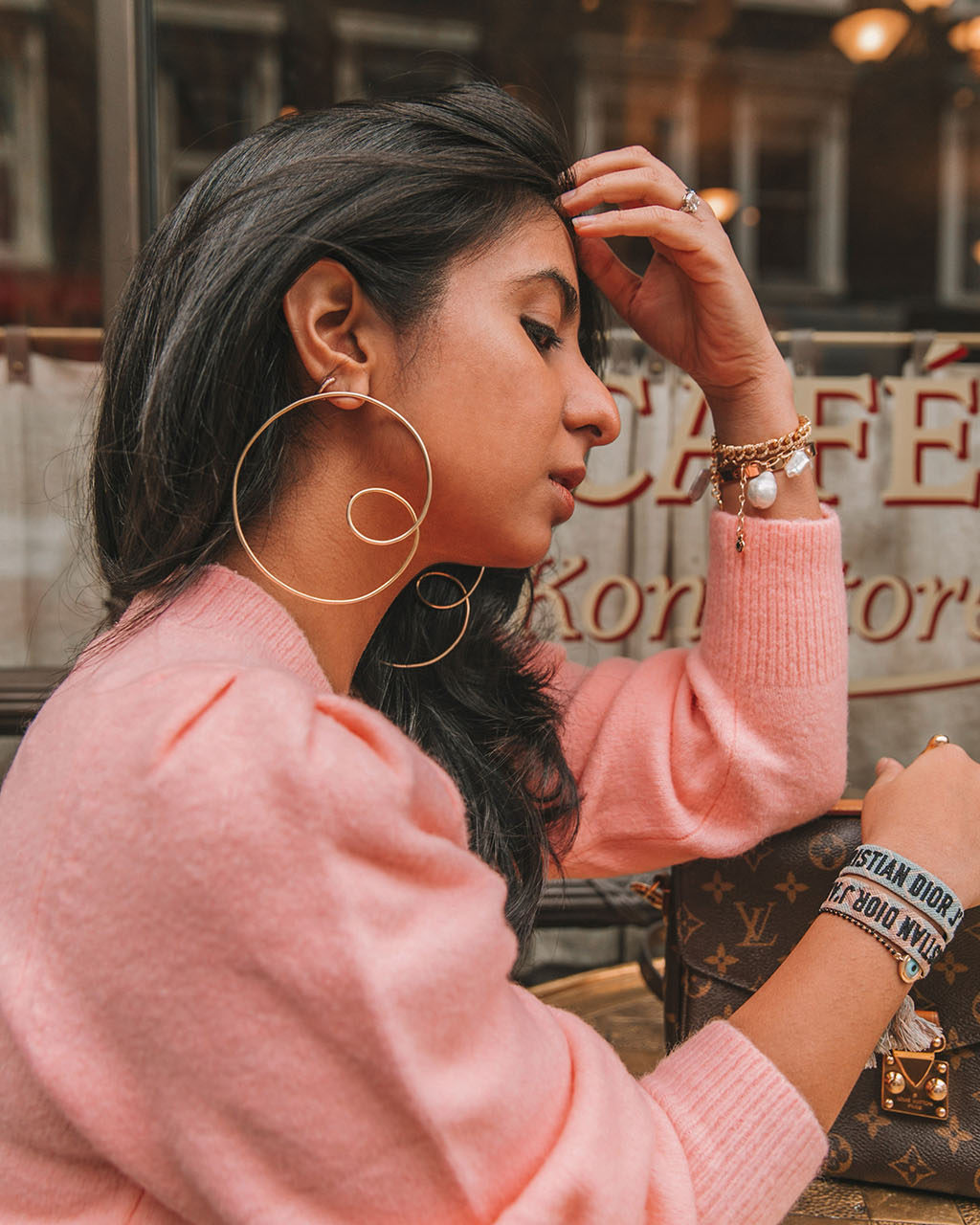 Luxury fashion blogger Shloka Narang of The Silk Sneaker shares how to wear cargo pants featuring cuffed Zara cargo pants and a pink & Other Stories Sweater with a Louis Vuitton Pochette Metis bag